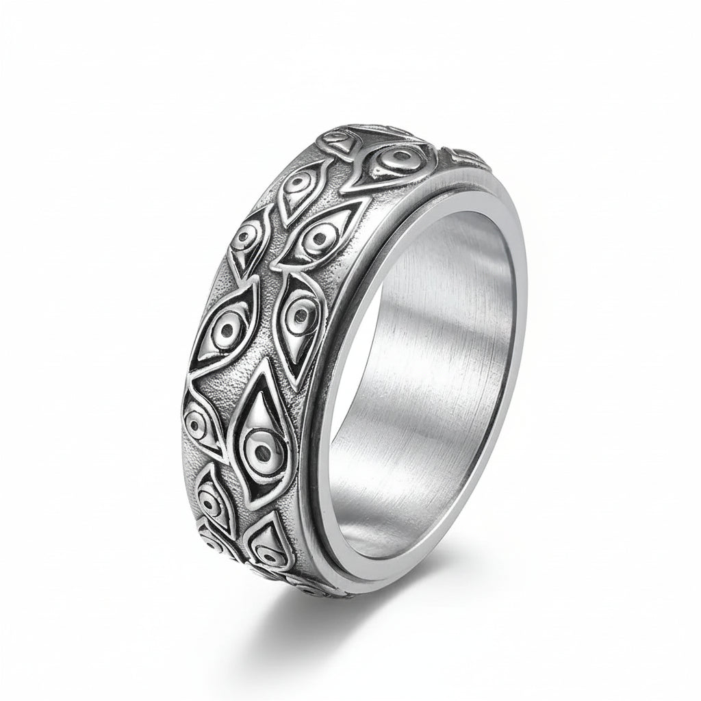 Silver ring with intricate patterns on a white background