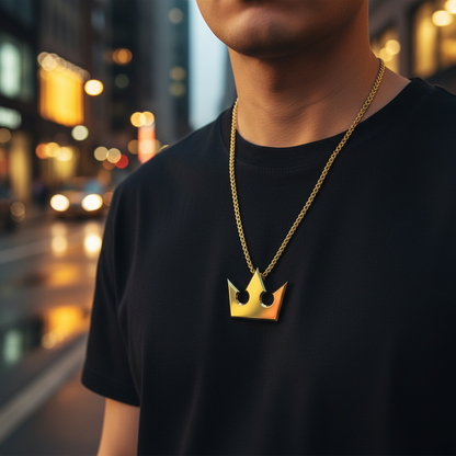 Person wearing a gold necklace with a crown pendant against a blurred city street background